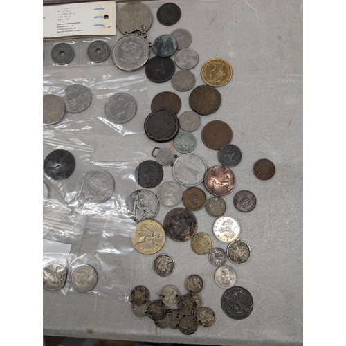 131 - Bundle of assorted mixed UK and international silver and copper coinage, notes and crowns