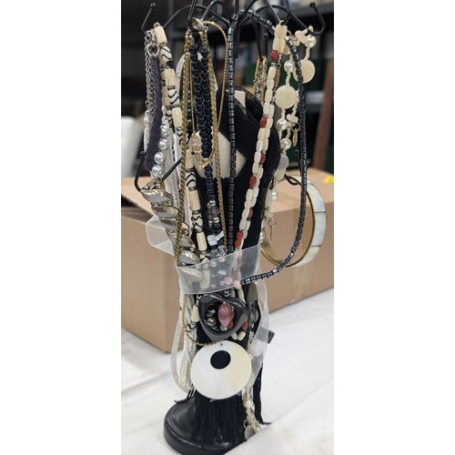 44 - Female mannequin with sequinned dress jewellery stand with assorted costume and dress necklaces