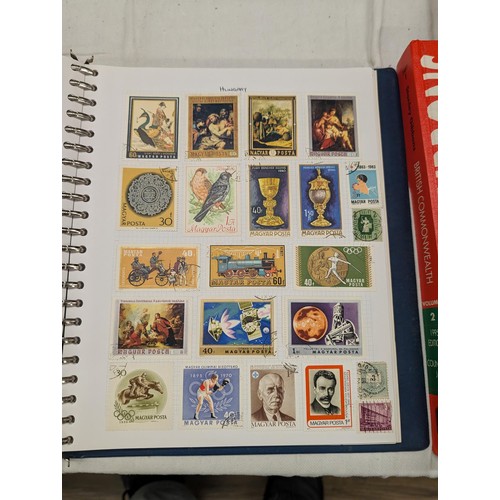 35 - Folder of modern stamps, Stanley Gibbons stamp catalogue and 2 x sheets of WWII christmas greeting a... 