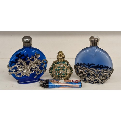 430 - Pair of First Impressions blue glass perfume bottles with ornate white metal overlay plus one other