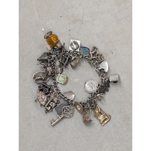 559 - Silver Charm bracelet crammed full of stamped and unstamped silver charms - 72.9gm