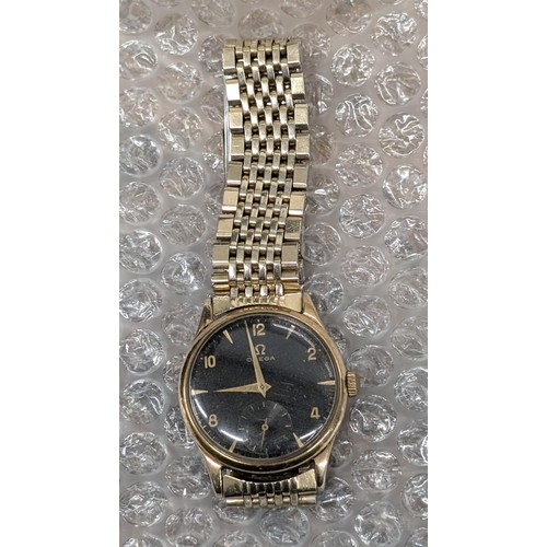 563 - Working Omega 9 carat gold cased watch with gold tone strap