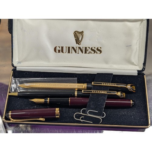 201 - Cased Guinness advertising biro and letter opener plus gold nibbed, squeeze fill fountain pen