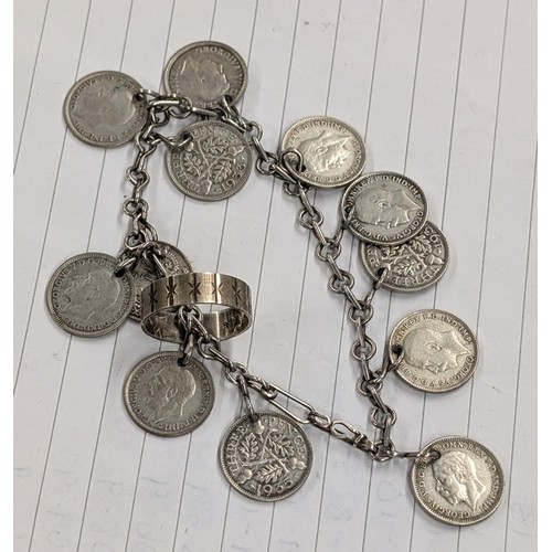 546 - Silver ring size O and unstamped white metal charm bracelet with 12 x UK 3 pence coins.