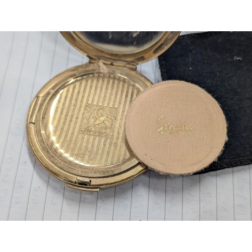 448 - Vintage gold tone Stratton compact with flower details in pouch.