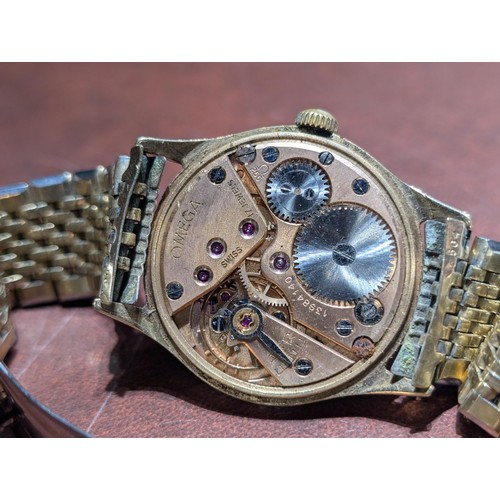 563 - Working Omega 9 carat gold cased watch with gold tone strap