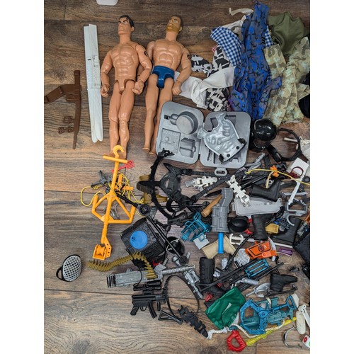 519 - 2 x Action men with bundle of clothes and accessories etc