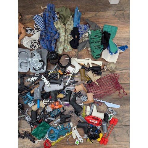 519 - 2 x Action men with bundle of clothes and accessories etc