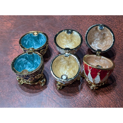 48 - Trio of near mint heavy gilt and enamelled Faberge style luxury ring/trinket egg shaped containers w... 