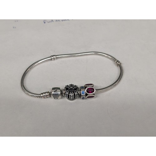 16 - Boxed genuine Pandora bracelet with 2 x charms and 1 x spacer charm