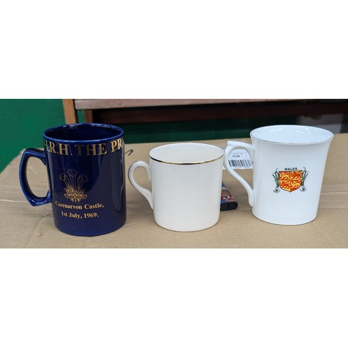 114 - Trio of mugs and cups to commemorate Charles Investiture