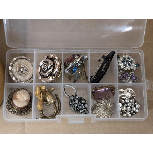 115 - 2 x small boxes, one plastic with small brooches one oval velvet with jewellery