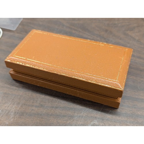 182 - Tan leather type box with assorted jewellery