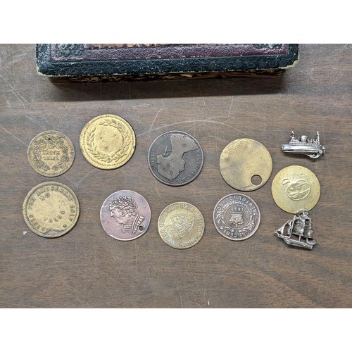 396 - Antique coins/tokens plus 2 x silver ship charms in Edwardian hairpin box