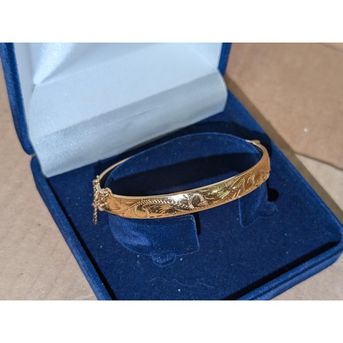 587 - Vintage half engraved rolled gold bangle with safety chain, stamped RG 25 microns