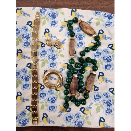 62 - Jewellery pouch containing vintage Malachite necklace, gold tone bracelet, earrings and brooch