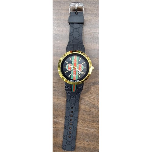 313 - Designer style gold tone and black rubber strap watch