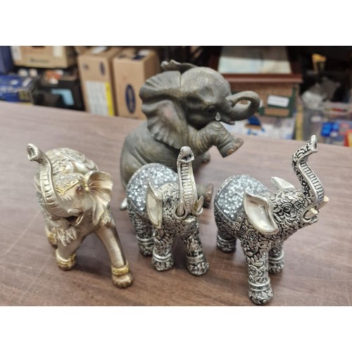 41 - 3 x Ornamental Indian elephant figures and 1 crying baby elephant figure- tallest being approximatel... 