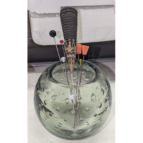 225 - 19th Century bubble glass pot with assorted old hat pins