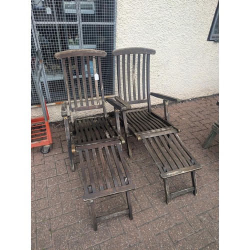 181 - Pair of weathered but sturdy old wooden steamer lounger chairs - 1 with broken seat slat and the oth... 