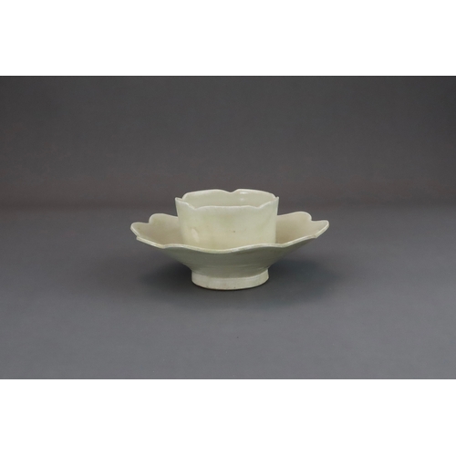 43 - An Extremely Rare Ding-type Lotus-form Cupstand, Five dynasties finely potted, the curved sides of t... 