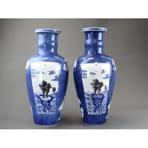 102 - A large Pair of Underglaze Red and Blue decorated Vases, Kangxi, each of tall ovoid form, the should... 