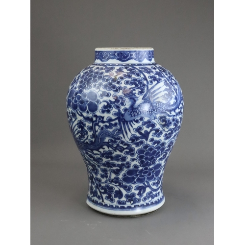 105 - A Blue and White Phoenix and Peony Vase, Kangxi of baluster shape,  painted to the sides in a contin... 