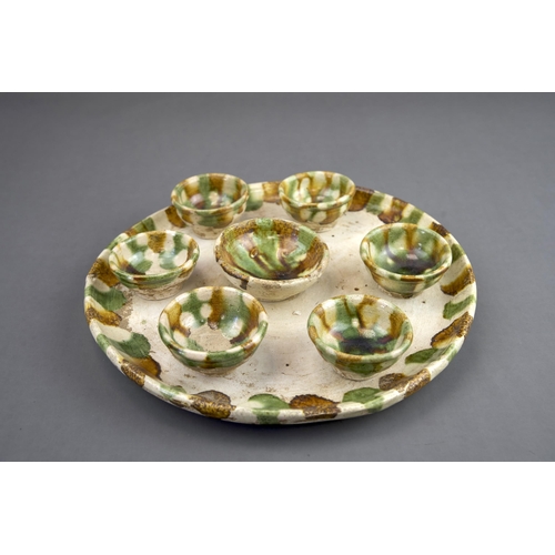 11 - A Set of Seven Sancai-glazed Wine Cups and Tray, Tang dynasty The circular tray raised on a ring foo... 