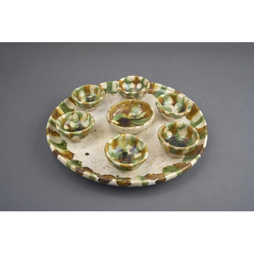 11 - A Set of Seven Sancai-glazed Wine Cups and Tray, Tang dynasty The circular tray raised on a ring foo... 