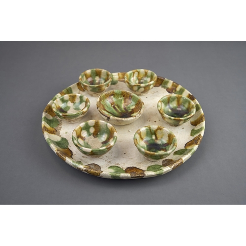 11 - A Set of Seven Sancai-glazed Wine Cups and Tray, Tang dynasty The circular tray raised on a ring foo... 