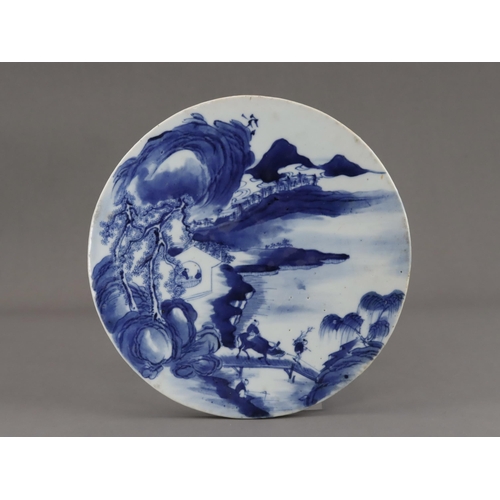 112 - A Blue and White Landscape Roundel, 19th century, well painted in inky tones of blue, with a misty m... 