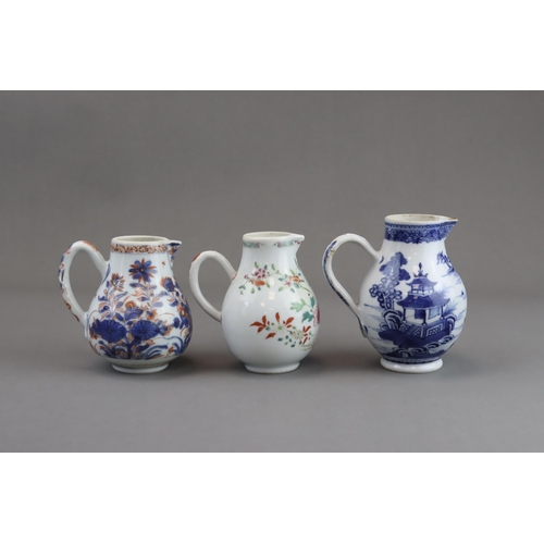 122 - Three Blue and White and 'famille rose' Milk Jugs, 18th century of pear shape with handle, two paint... 