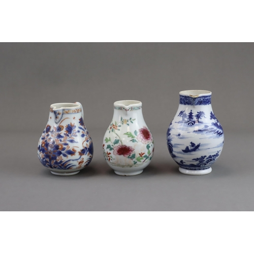 122 - Three Blue and White and 'famille rose' Milk Jugs, 18th century of pear shape with handle, two paint... 