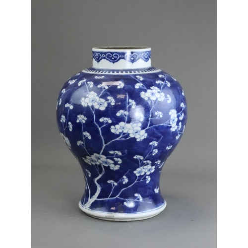 127 - A Blue and White Baluster Vase with Prunus, Kangxi the sides painted in deep tones with pendent flow... 