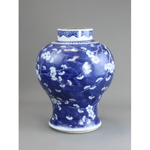 127 - A Blue and White Baluster Vase with Prunus, Kangxi the sides painted in deep tones with pendent flow... 