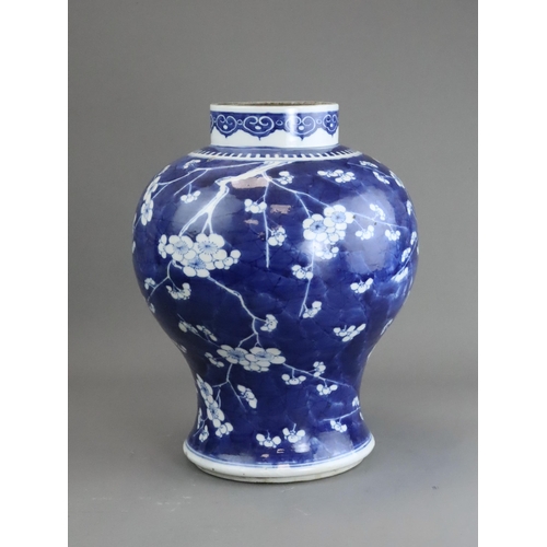 127 - A Blue and White Baluster Vase with Prunus, Kangxi the sides painted in deep tones with pendent flow... 