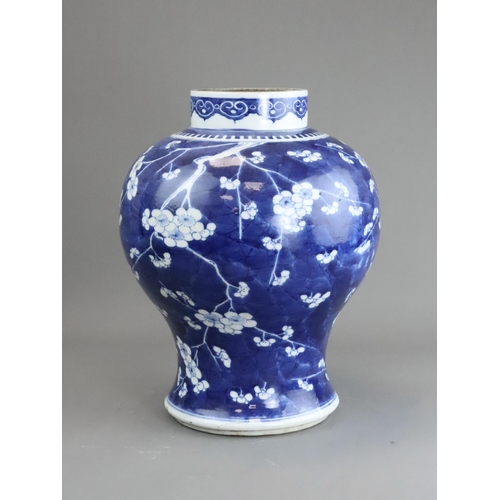 127 - A Blue and White Baluster Vase with Prunus, Kangxi the sides painted in deep tones with pendent flow... 