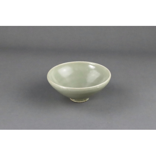 16 - A Yaozhou 'Moon White' Conical Bowl, Five dynasties the deep rounded sides rising from a short strai... 