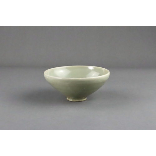 16 - A Yaozhou 'Moon White' Conical Bowl, Five dynasties the deep rounded sides rising from a short strai... 