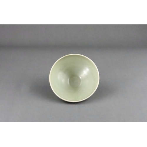 16 - A Yaozhou 'Moon White' Conical Bowl, Five dynasties the deep rounded sides rising from a short strai... 