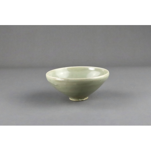 16 - A Yaozhou 'Moon White' Conical Bowl, Five dynasties the deep rounded sides rising from a short strai... 