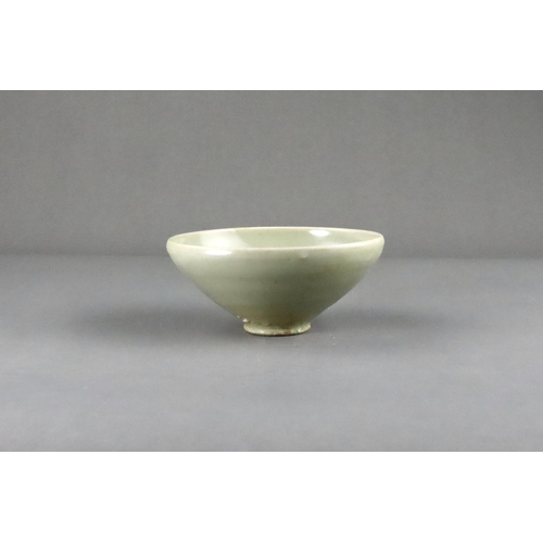 16 - A Yaozhou 'Moon White' Conical Bowl, Five dynasties the deep rounded sides rising from a short strai... 