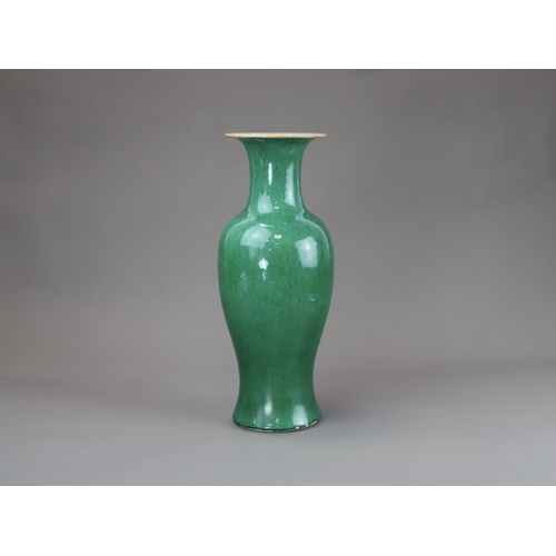 164 - An Apple Green Vase, Qing dynasty, of slender baluster form with waisted neck flaring to the mouth, ... 