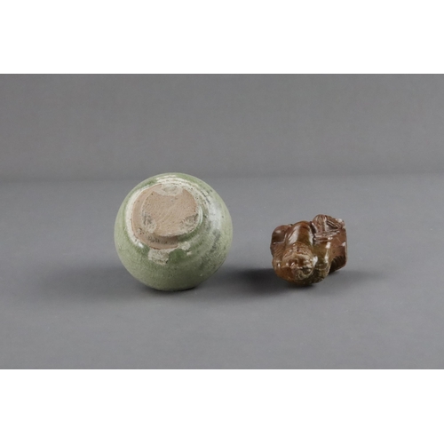 23 - An Amber-glazed Figure and A Celadon Cup, Han dynasty and Sui dynasty a sitting male figure in robe,... 