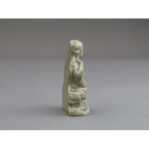 29 - A Rare Miniature Yaozhou Celadon-glazed Figure of a Monk, Song dynasty  The figure wearing long robe... 