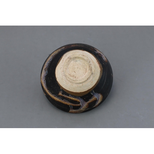 32 - A Jizhou Phosphatic-splash Bowl, Song dynasty of conical form with incurved mouth, overall in black ... 