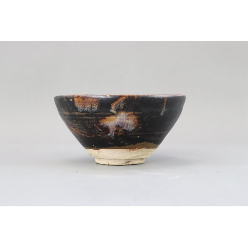 32 - A Jizhou Phosphatic-splash Bowl, Song dynasty of conical form with incurved mouth, overall in black ... 