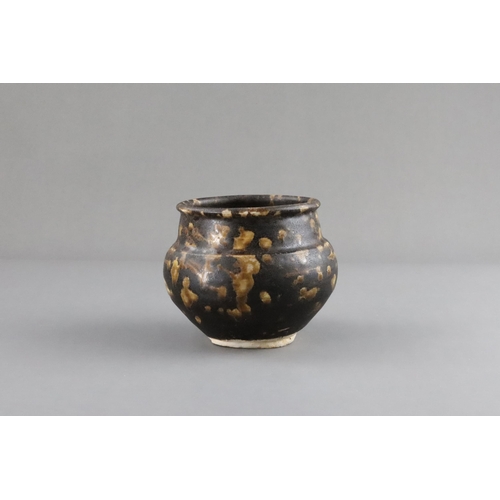 35 - A Jizhou Tortoiseshell Jar, Song dynasty the compressed ovoid body supported on a narrow foot, swell... 