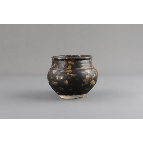 35 - A Jizhou Tortoiseshell Jar, Song dynasty the compressed ovoid body supported on a narrow foot, swell... 