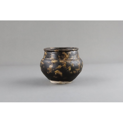 35 - A Jizhou Tortoiseshell Jar, Song dynasty the compressed ovoid body supported on a narrow foot, swell... 